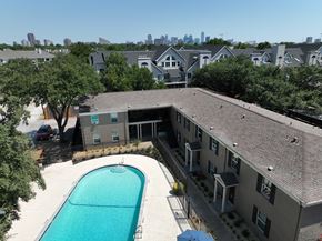 Dallas apartment for rent - an aerial view of an apartment building with a swimming pool