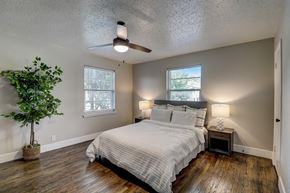 Dallas apartment for rent - a bedroom with a bed and a ceiling fan