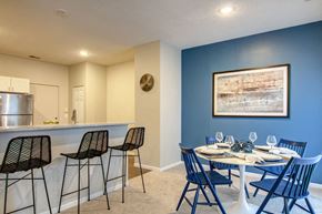 Woodbury apartment for rent - a dining area with a table and chairs and a kitchen in the background