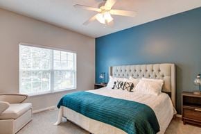 Woodbury apartment for rent - a bedroom with a bed and a ceiling fan