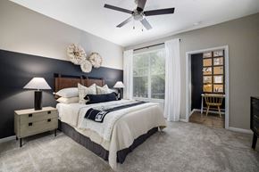 Cary apartment for rent - a bedroom with a bed and a ceiling fan at Tradition at Stonewater, Cary, NC, 27519