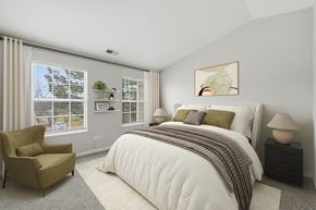 Warrenville apartment for rent - A bedroom with a large bed and a chair.