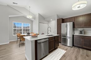 Warrenville apartment for rent - A modern kitchen with a dining table and chairs.