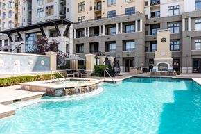 Denver apartment for rent - A large swimming pool in front of a building.