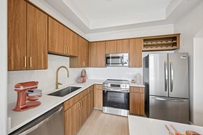 Denver apartment for rent - A kitchen with wooden cabinets and stainless steel appliances.