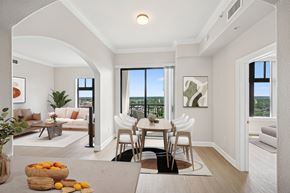 Denver apartment for rent - A dining room with a table and chairs and a view of the city.