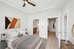 Denver apartment for rent - A bedroom with a large bed and a painting on the wall.