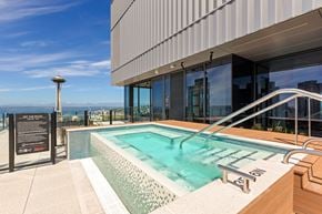 Seattle apartment for rent - a swimming pool on the rooftop of a building with a view of the city