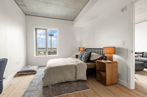 Seattle apartment for rent - a bedroom with a bed and a couch and a window