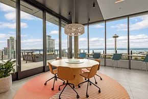 Seattle apartment for rent - a dining room with a view of the ocean and a table and chairs