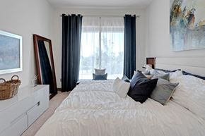 Jacksonville apartment for rent - a bedroom with a large bed and a window with curtains