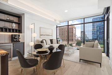 Dallas apartment for rent - A modern living room with a glass table and chairs.