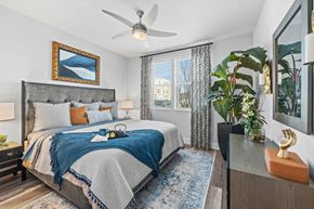 Melbourne apartment for rent - A bedroom with a large bed and a ceiling fan.
