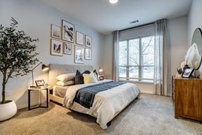 Broomfield apartment for rent - a bedroom with a large window and framed pictures on the wall at Arista Uptown Apartments, Broomfield