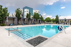 Broomfield apartment for rent - a swimming pool with a building in the background at Arista Uptown Apartments, Broomfield, CO, 80021