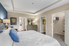 Alpharetta apartment for rent - A bedroom with a large bed and a dresser.