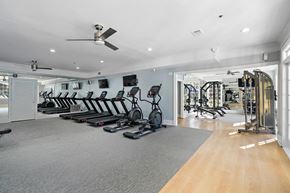 Alpharetta apartment for rent - A spacious gym with treadmills, elliptical machines, and other exercise equipment.