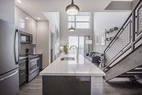 Boston apartment for rent - a kitchen with a white counter top and a staircase