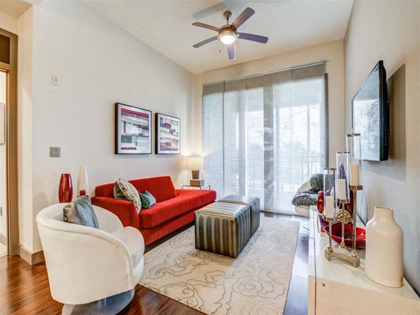 Jacksonville apartment for rent - a living room with a red couch and a large window