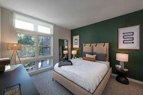 Conshohocken apartment for rent - a bedroom with a large bed and a green accent wall