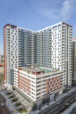 Tampa apartment for rent - A modern multi-story building with a pool on the top floor.