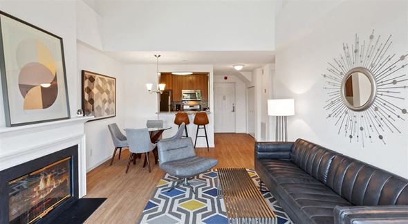 Bronxville apartment for rent - a living room with a leather couch and a fireplace