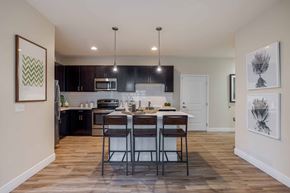 Denver apartment for rent - A kitchen with a table and chairs in the middle of the room.