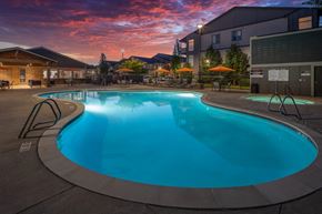 Camas apartment for rent - a swimming pool at dusk at a hotel with a sunset in the background