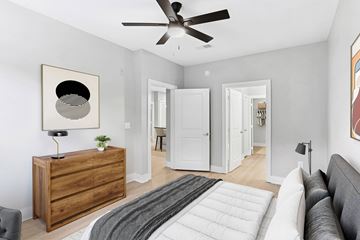 Atlanta apartment for rent - A modern living room with a grey couch and a wooden dresser.