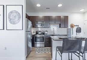 Broomfield apartment for rent - a kitchen with wooden cabinets and stainless steel appliances at RockVue, Broomfield, CO