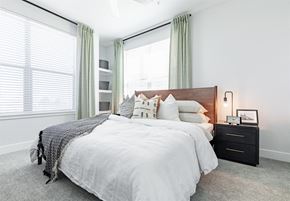 Broomfield apartment for rent - a bedroom with two windows and a bed with a white comforter and pillows at RockVue, Broomfield, 80021