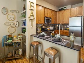 Houston apartment for rent - a kitchen with a counter top and stools at Retreat at Shadow Creek Ranch Apartments, Houston, TX, 77584
