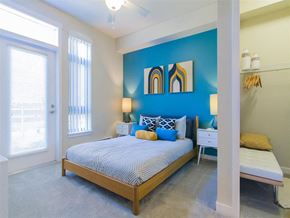 Bothell apartment for rent - a bedroom with a bed and a blue wall