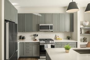 Tempe apartment for rent - A modern kitchen with a stove top oven and a refrigerator.