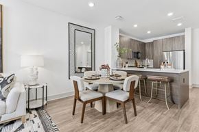Hyannis apartment for rent - A modern dining room with a wooden table and chairs.