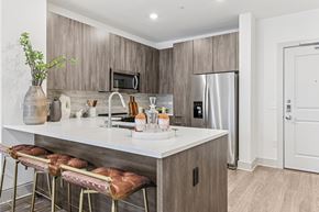 Hyannis apartment for rent - A kitchen with a white counter top and brown bar stools.