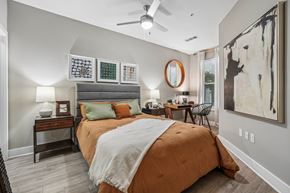 Charlotte apartment for rent - A bedroom with a large bed and a ceiling fan.