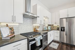 Hingham apartment for rent - a modern kitchen with stainless steel appliances and white cabinets