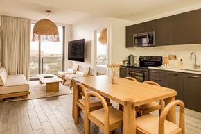 Fort Lauderdale apartment for rent - A modern kitchen with a wooden table and chairs.