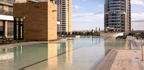 Fort Lauderdale apartment for rent - A pool in a city setting with a tall building in the background.