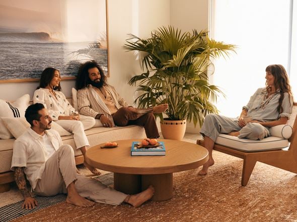 Miami apartment for rent - A group of people are sitting on a couch and a chair in a living room.