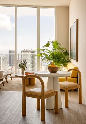 Miami apartment for rent - A dining room with a table, chairs and a view of the city.