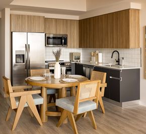 Miami apartment for rent - A modern kitchen with a round table set for four.