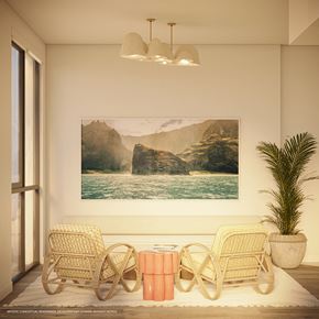 Miami apartment for rent - Two wicker chairs are placed on a white rug in front of a painting of a mountain landscape.