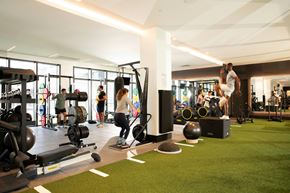 Miami apartment for rent - A gym with people working out and various equipment.