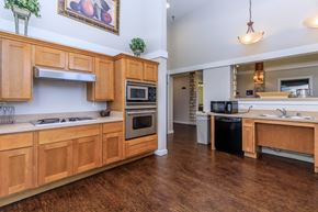 Dallas apartment for rent - a kitchen with wooden cabinets and stainless steel appliances