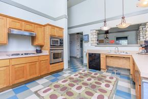 Dallas apartment for rent - a kitchen with wooden cabinets and stainless steel appliances