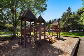 Everett apartment for rent - a playground with a swing set and other play equipment at Eagles Landing Apartments, Everett, 98204