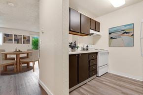 Everett apartment for rent - a kitchen and dining room area with a table and chairs and a wall at Eagles Landing Apartments, Washington