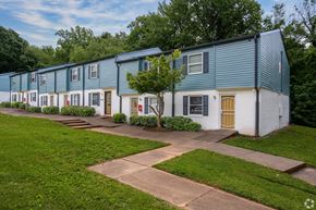 Winston-Salem apartment for rent - a row of houses with blue and white siding and a sidewalk